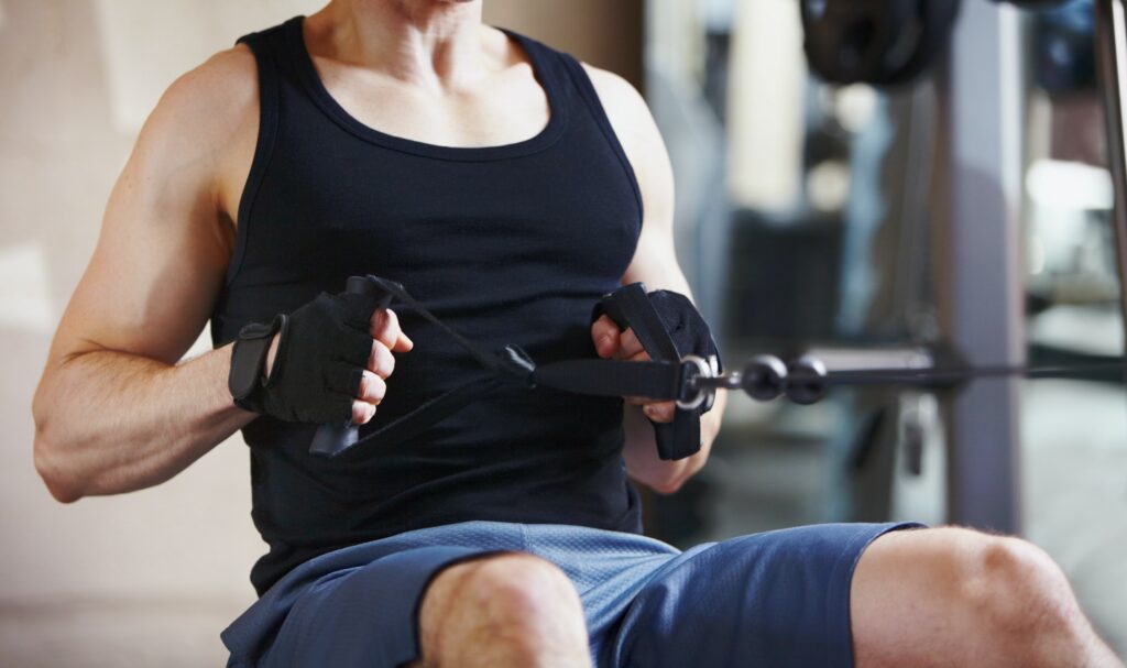 Strengthening his core. Cropped image of a mature man using the cable row machine at the gym.