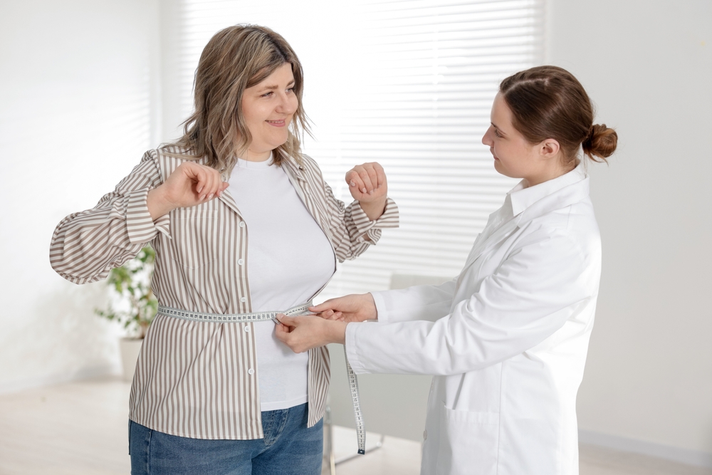 Healthcare provider measuring patient progress with weight loss programs in Ellicott City MD